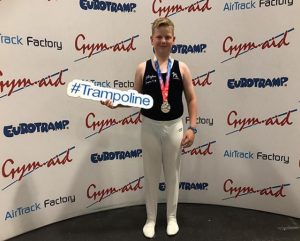 Andrew Mclaren posing with his silver medal at NDP Finals